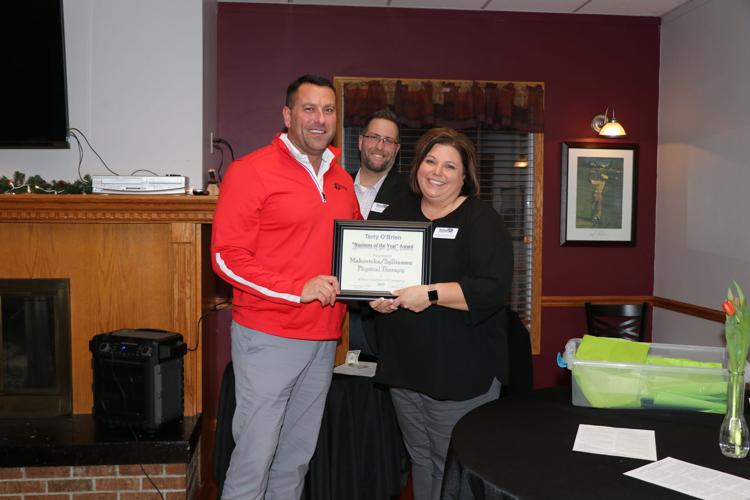 Cory Sylliaaasen accepts the Business of the Year award from Chamber Executive Assistant Jennifer Woita and Chamber President Ryan Ideus. 