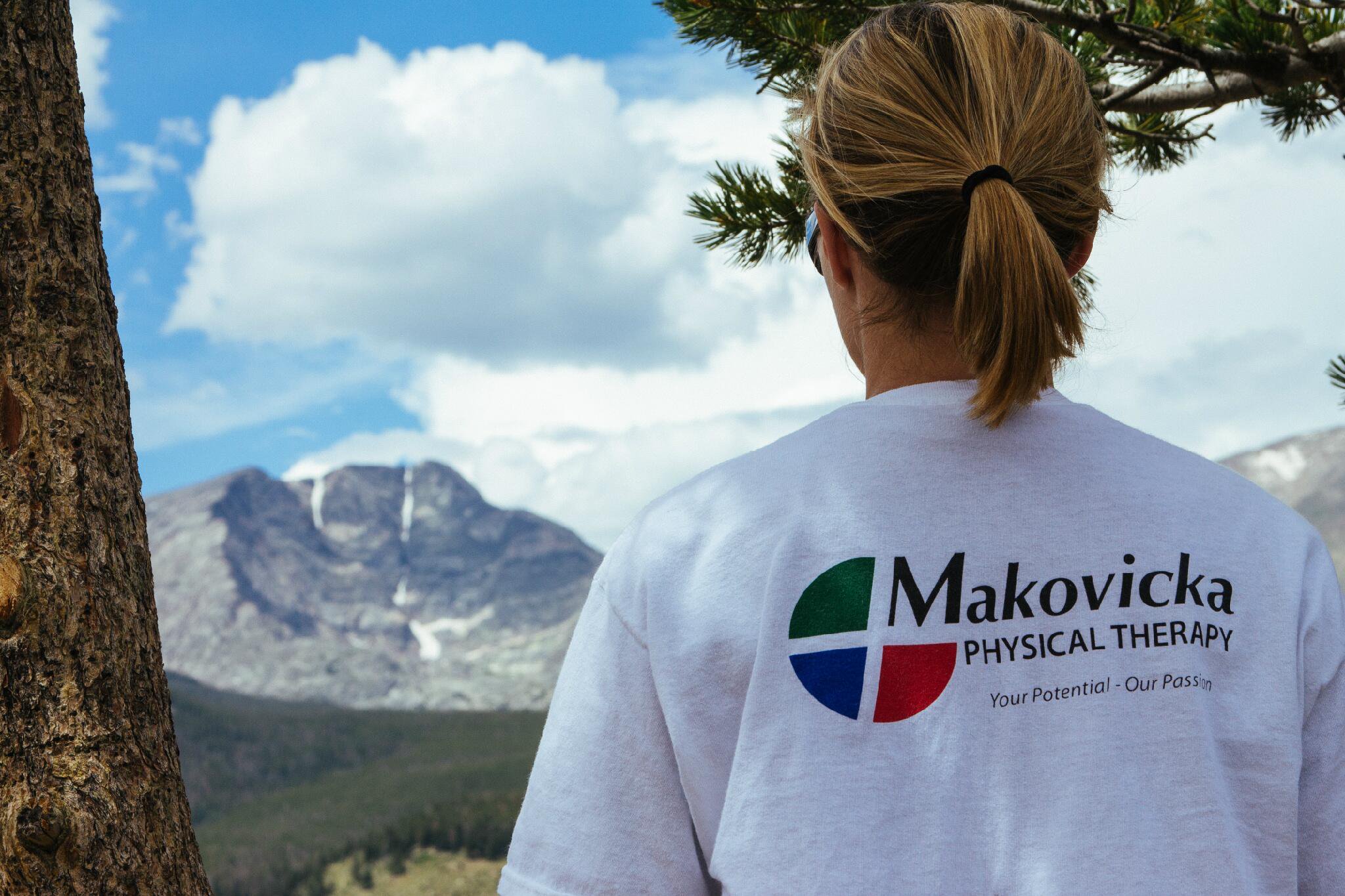 Woman at mountain overlook wearing Makovicka Physical Therapy T-Shirt